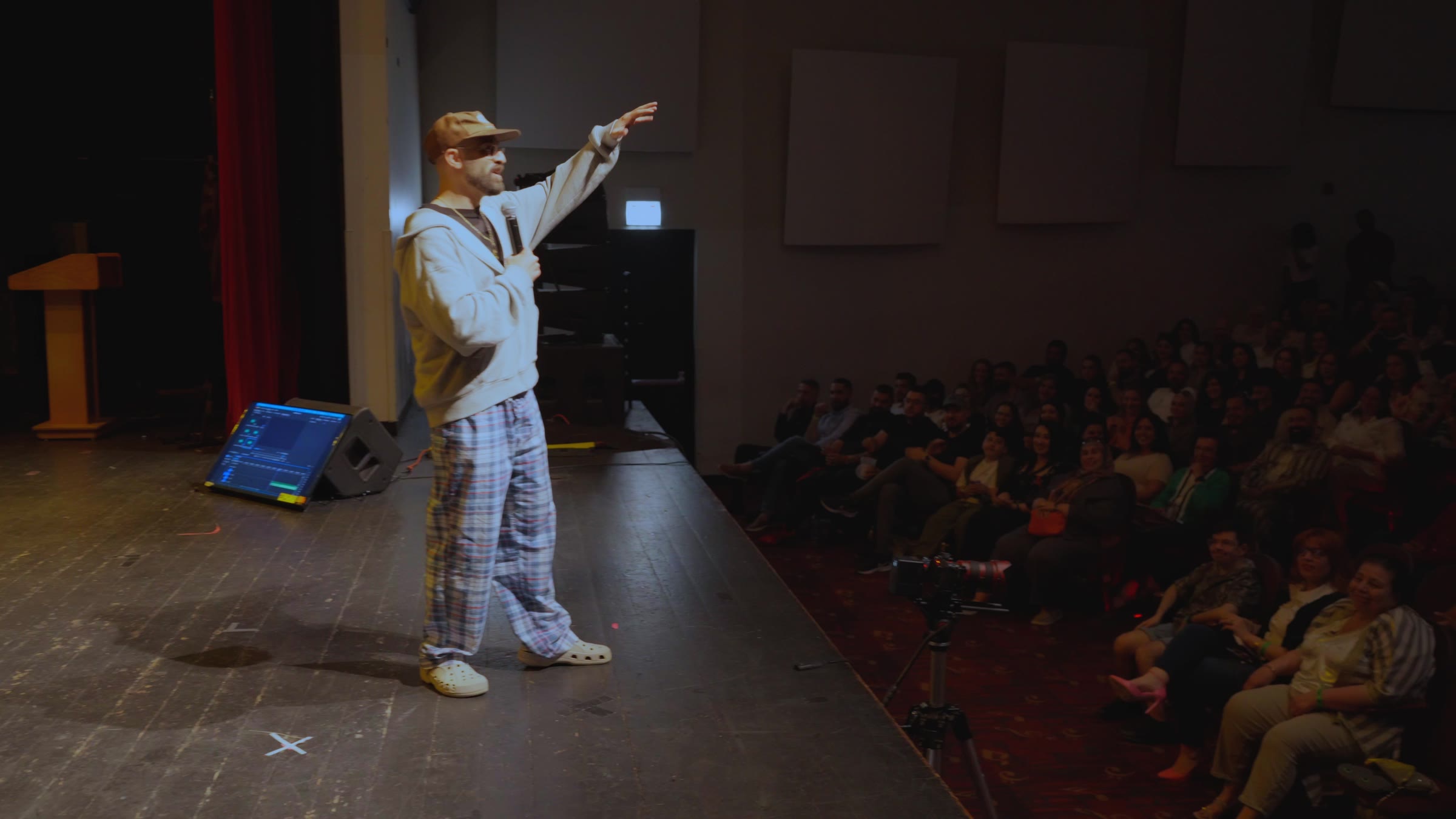 Younis Dhaher performing stand-up for a live audience